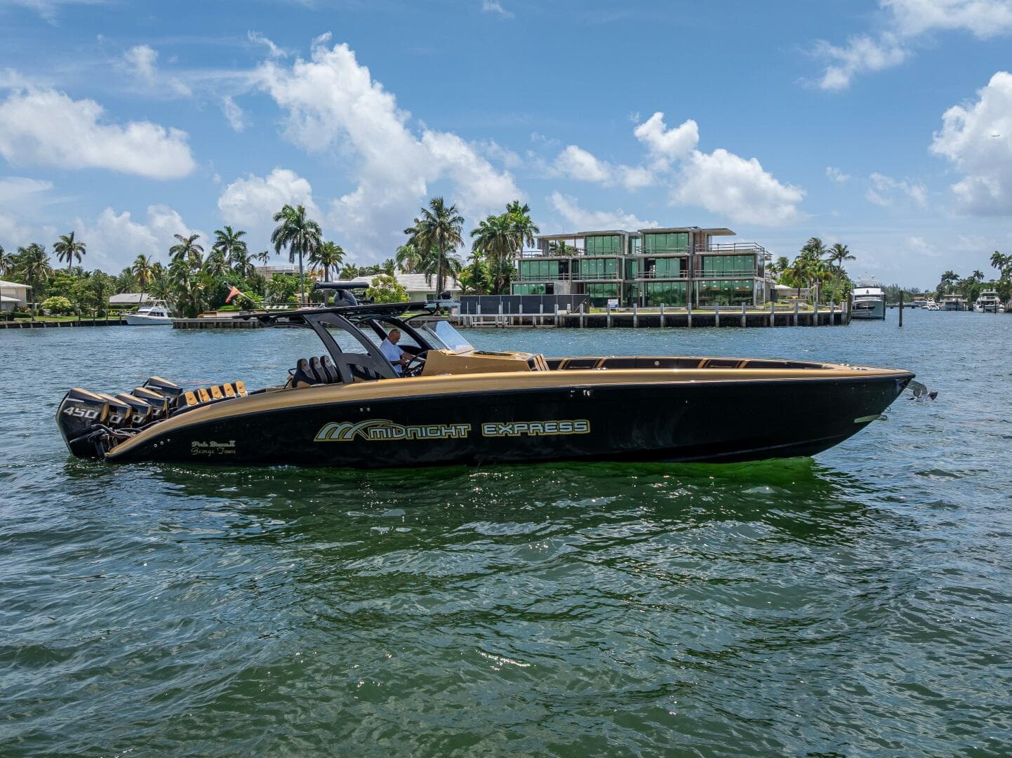 The black and gold 43' Midnight Express on the water